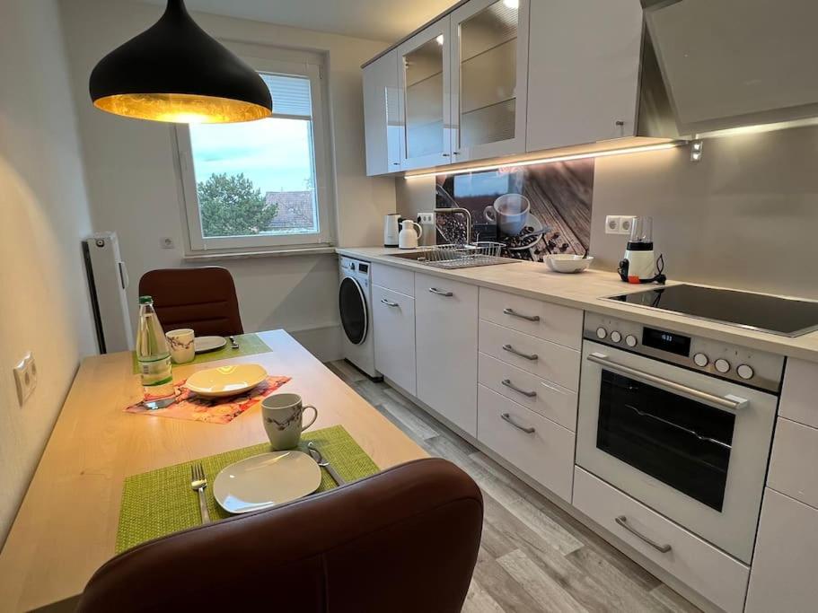 a kitchen with a table and a counter top at Moderne stilvolle Gästewohnung in Werdau