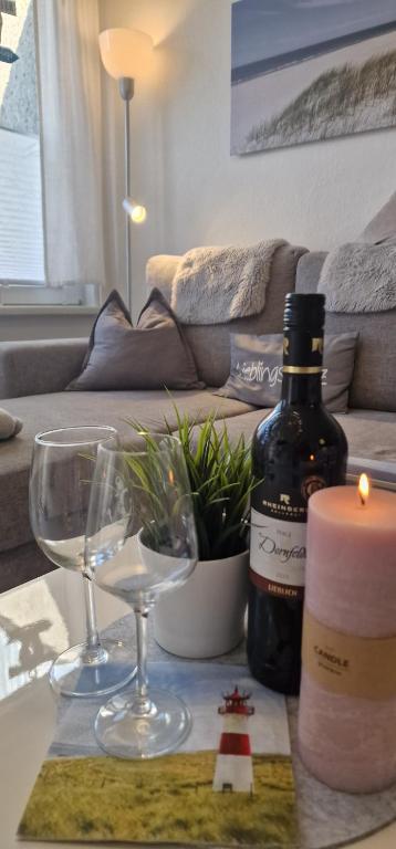 a table with a bottle of wine and two glasses at Haus Vineta in Barth