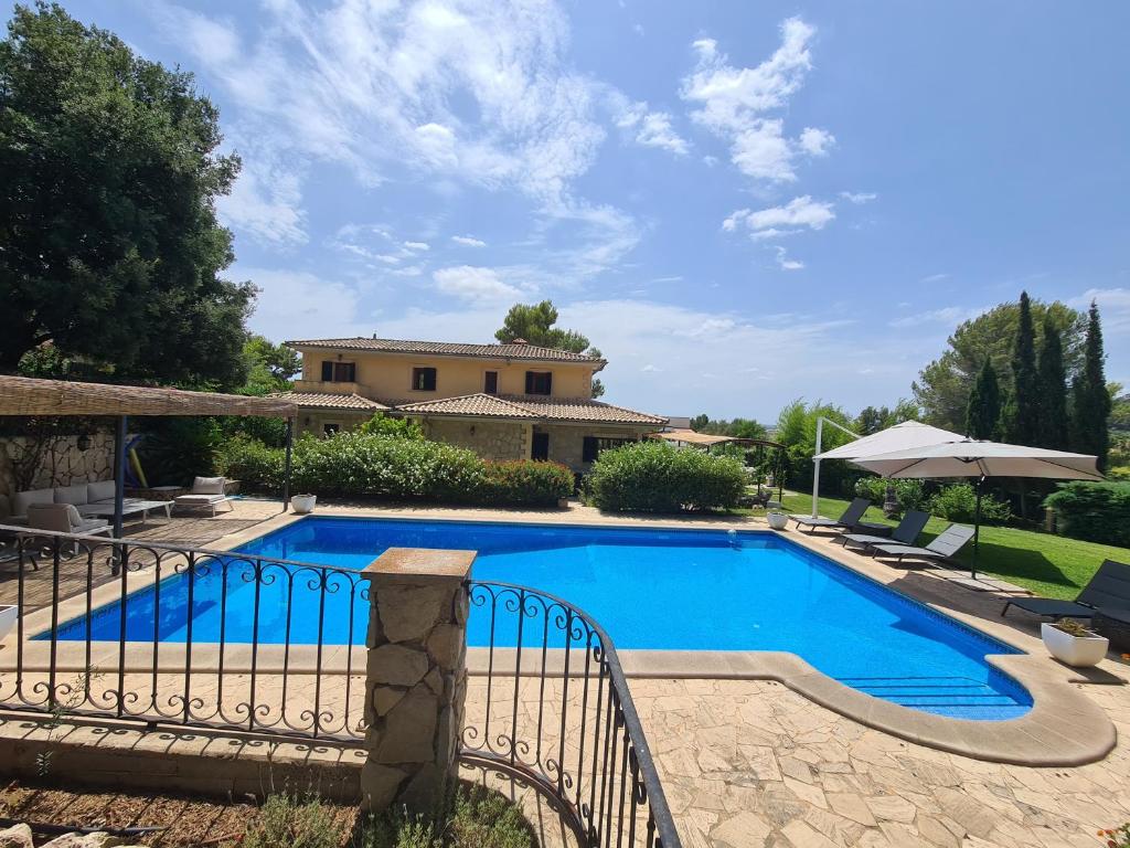 a swimming pool in front of a villa at VILLA JACELIA in Sa Pobla