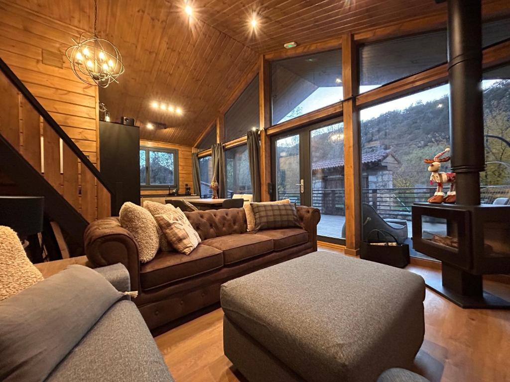 a living room with a couch and a large window at Casa rural Los Pilares de la Sierra in Arahuetes