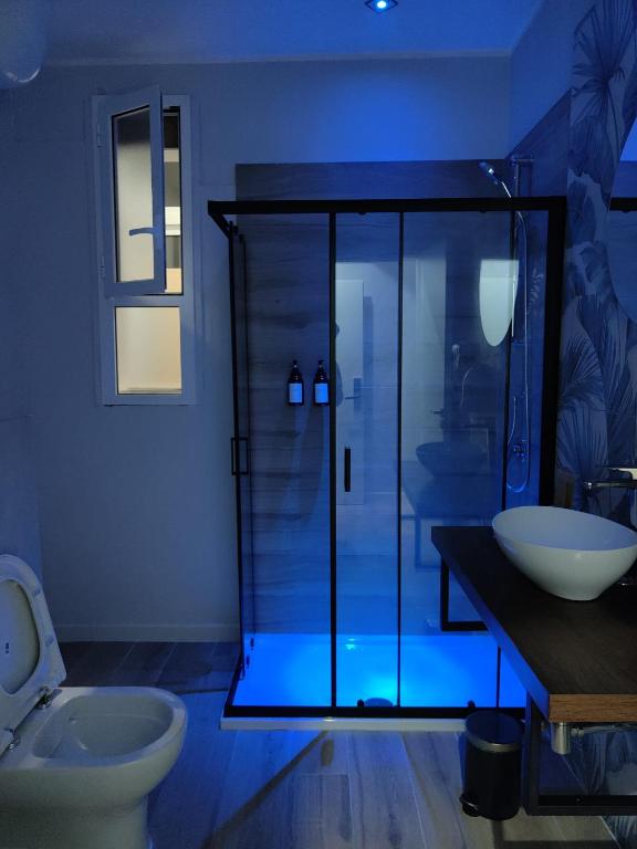 a bathroom with a glass shower and a toilet at Cuore Napoli Centro in Naples