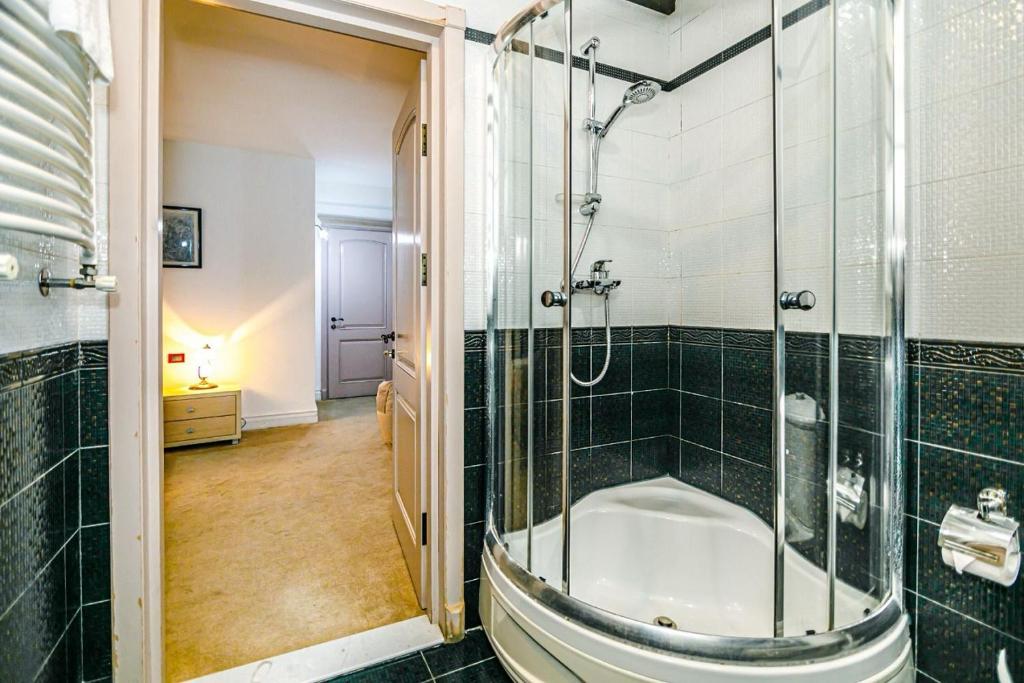 a bathroom with a shower and a bath tub at Coffee time hotel in Baku