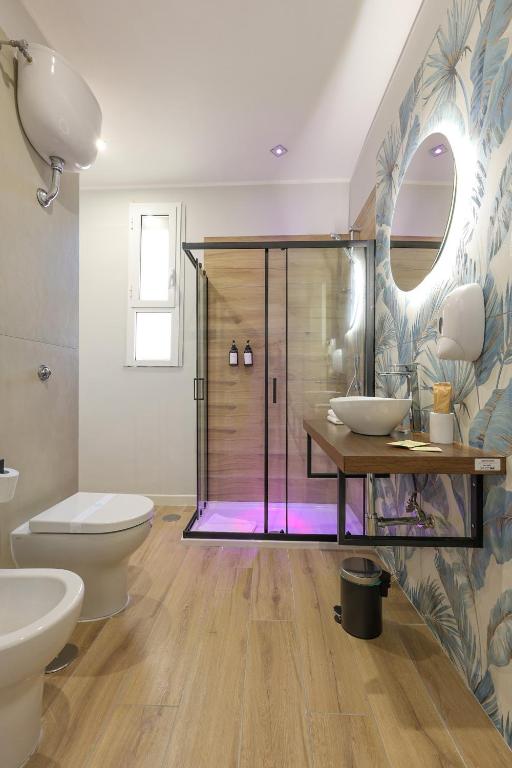 a bathroom with a shower and a toilet and a sink at Cuore Napoli Centro in Naples