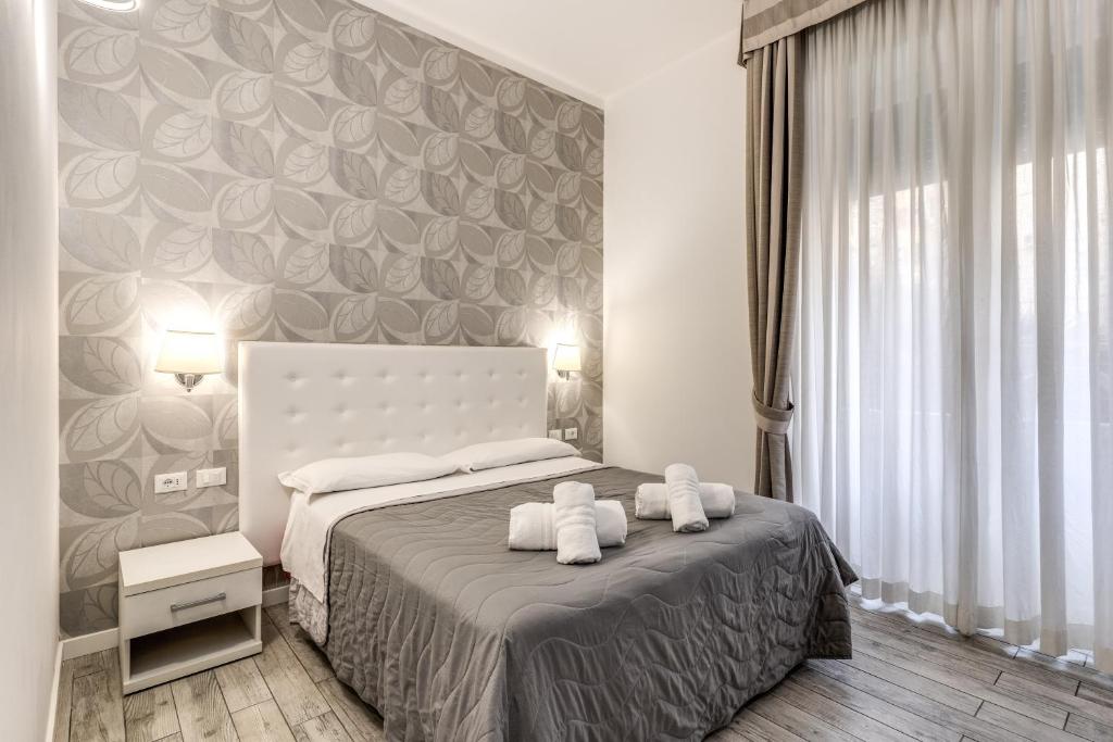 A bed or beds in a room at Gardenia Suite