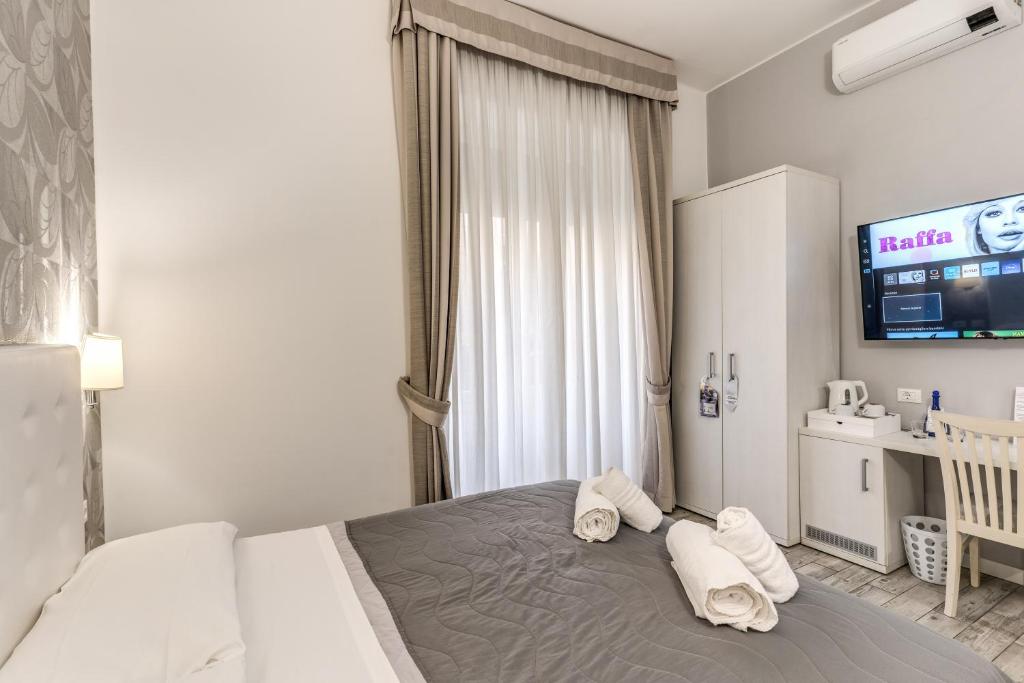 A bed or beds in a room at Gardenia Suite