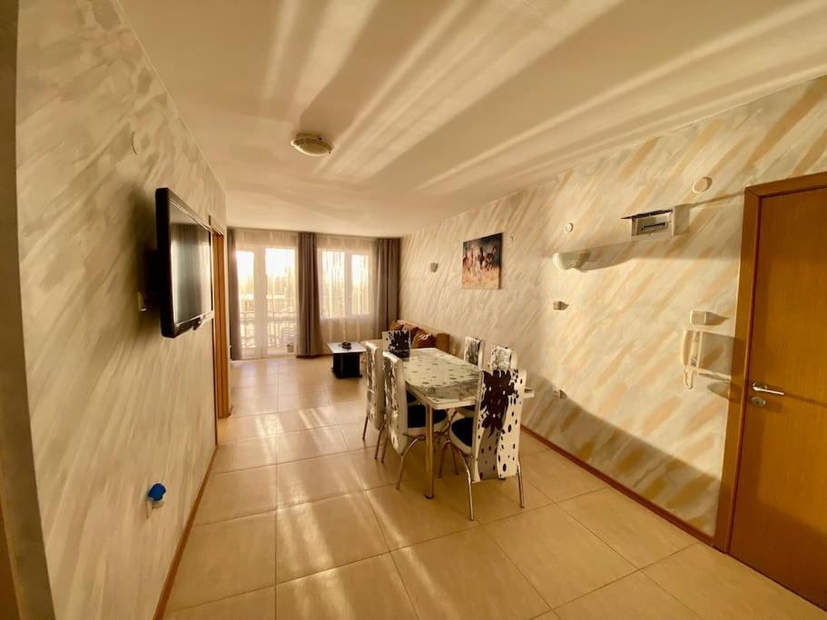 a dining room with a table with chairs and a television at “Sunny Beach Hills” Apartment B2.8 in Sunny Beach