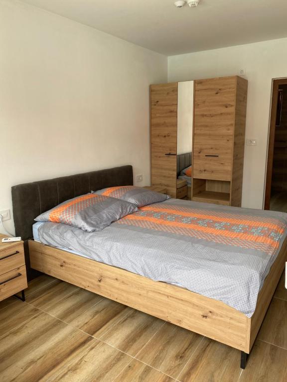 a bedroom with a bed with a wooden frame at Vikendica za odmor Laktasi in Laktaši