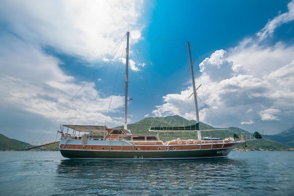 a boat sitting in the water on a lake at Traditional Sailing Yacht in Tivat