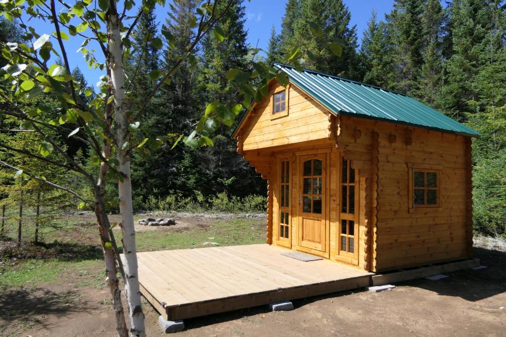 a small wooden cabin with a wooden deck at Deer Meadow #1 in Maynooth