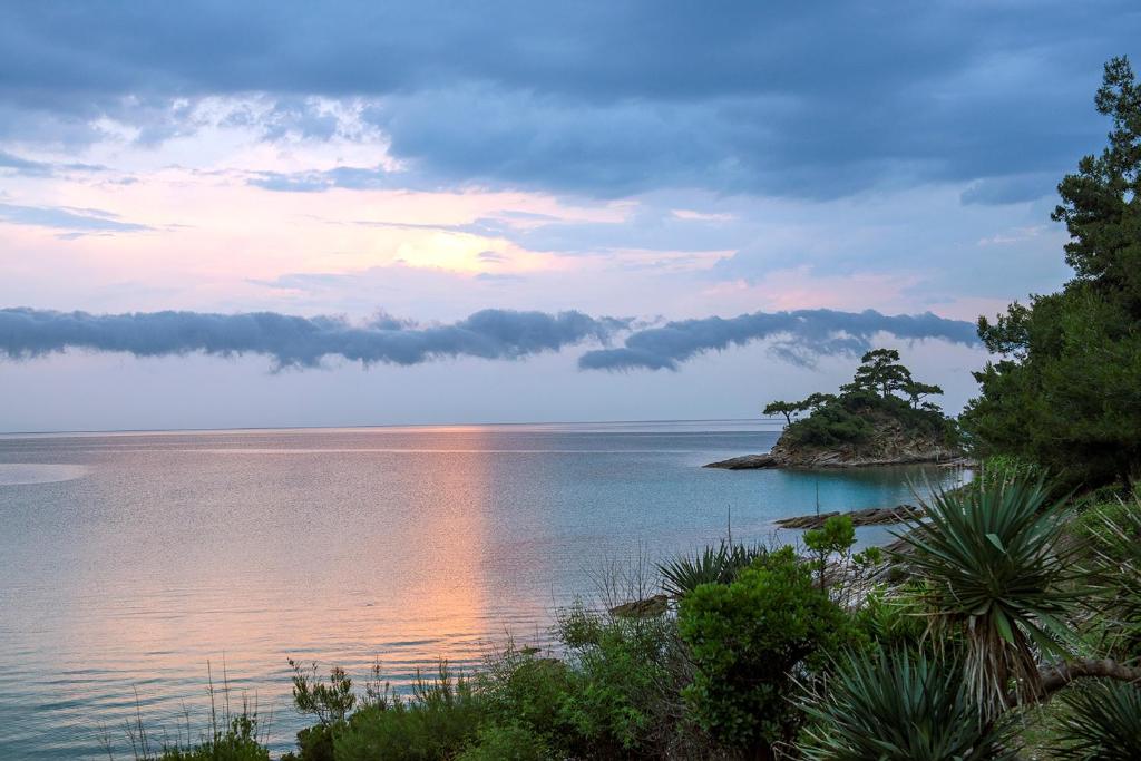 an island in the middle of a body of water at Makryammos in Limenas