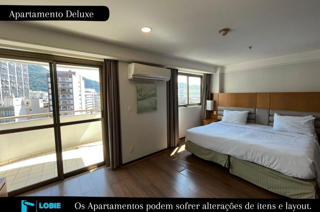 a bedroom with a bed and a large window at Lobie Botafogo Privilege in Rio de Janeiro