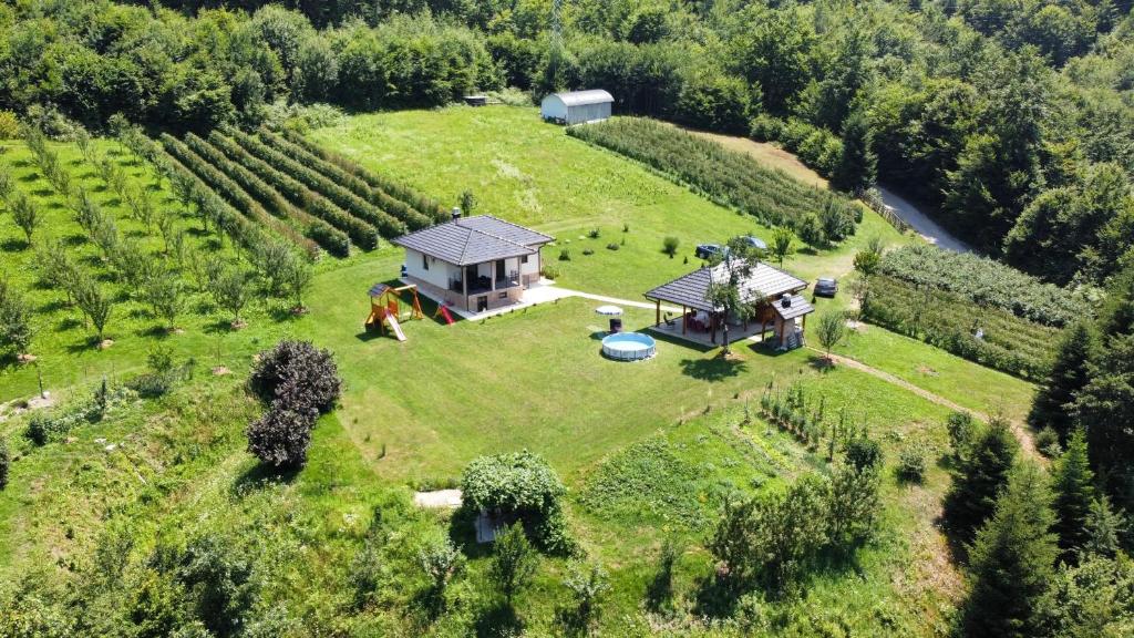 an aerial view of a house on a green field at Vila Mana in Ivanjica