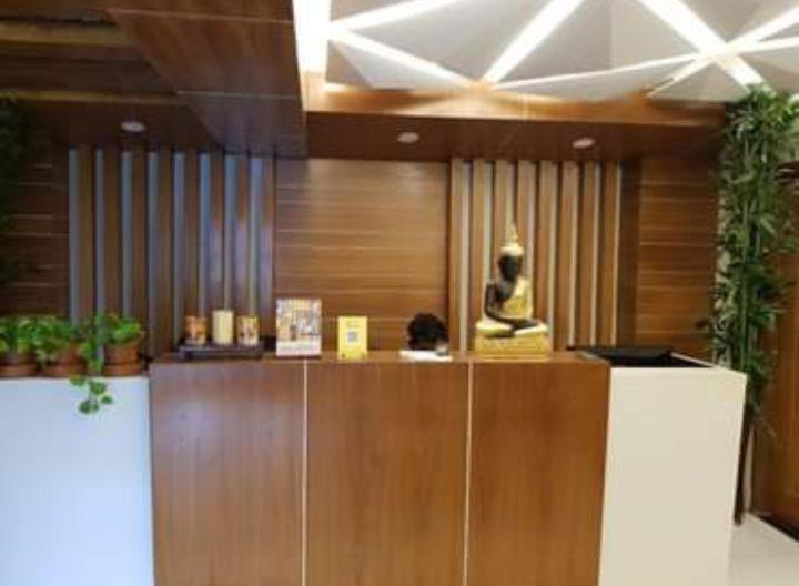 a lobby with a counter with a statue on it at Spas Personal Care in Dhaka