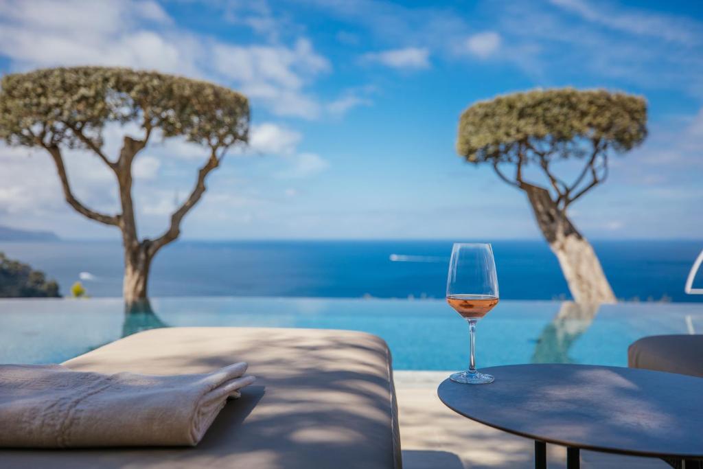a glass of wine sitting on top of a table at Villa Fiorella Art Hotel in Massa Lubrense