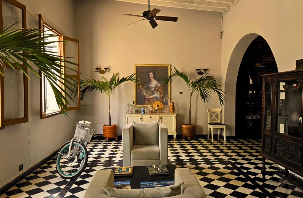 a living room with a couch and a table at Casa Charlotte - Alma Hotels in Santa Marta