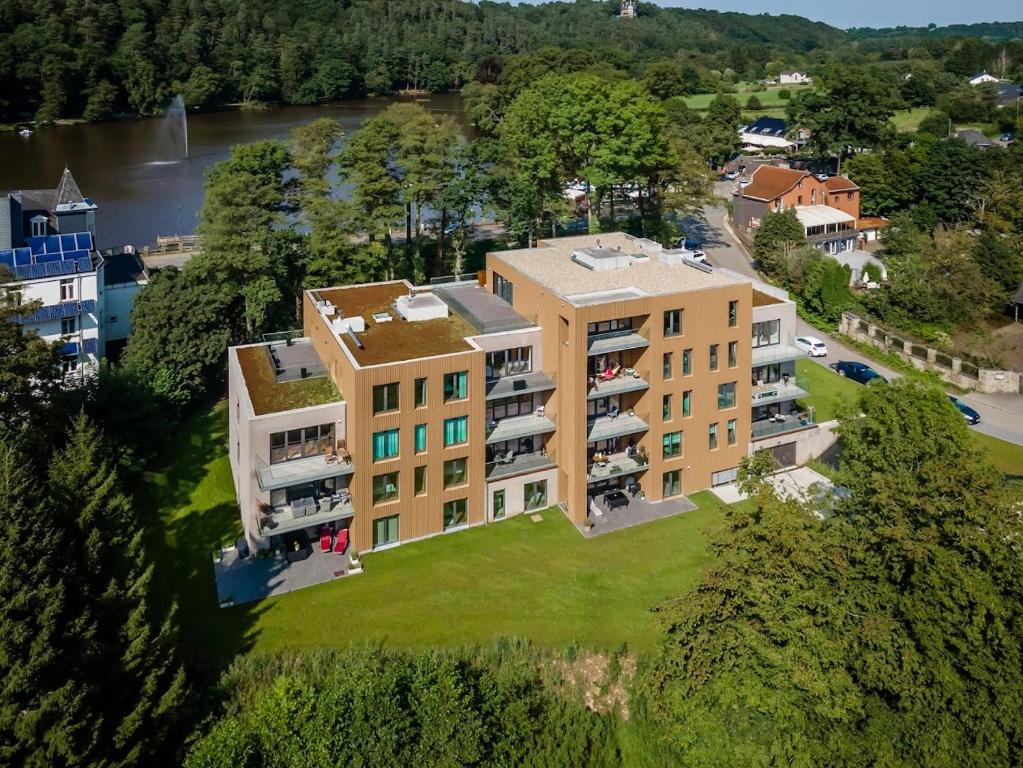 an aerial view of a building with a yard at Penthouse au lac de Warfaaz in Spa