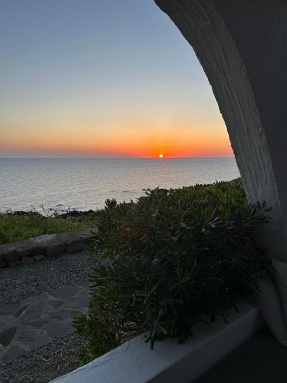 a sunset over the ocean from a patio at Punta Tre Pietre 37 - Vista Tramonto in Scauri