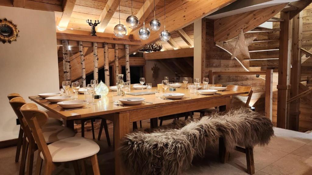 a large wooden table in a room with chairs at Chalet Totoro - Chalets pour 14 Personnes 514 in Valloire