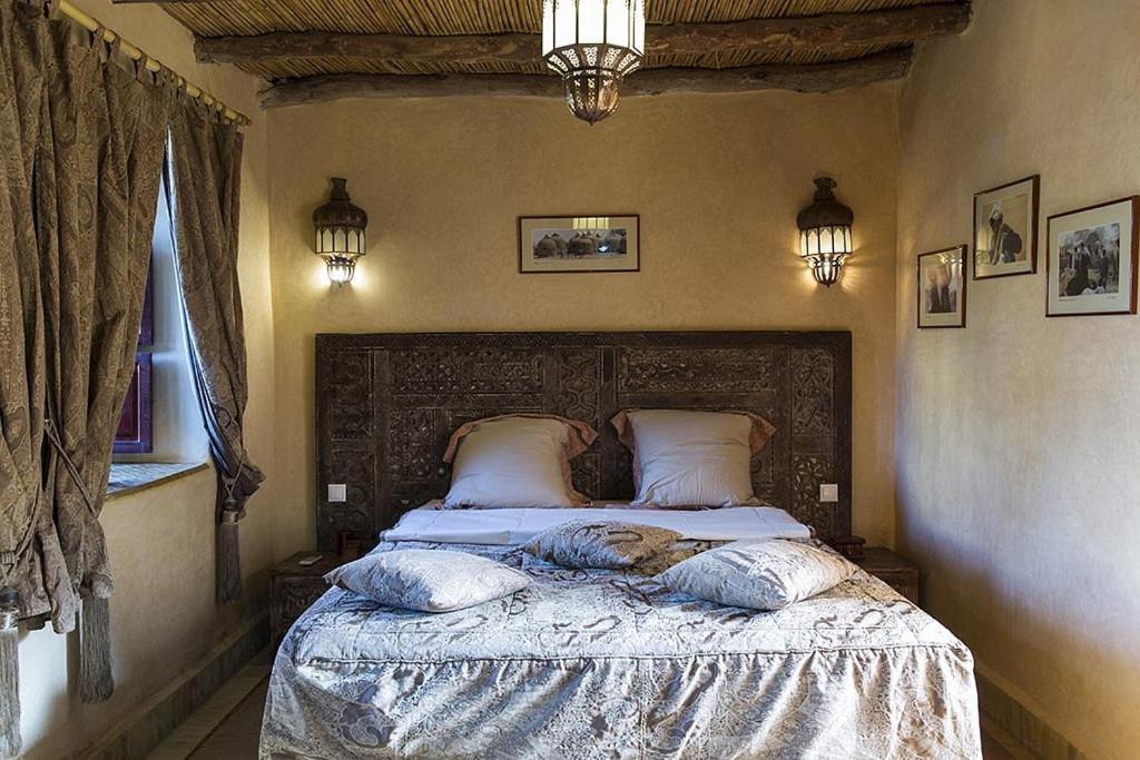 El Arba的住宿－Riad des 1001 Fleurs，一间卧室配有带枕头的床