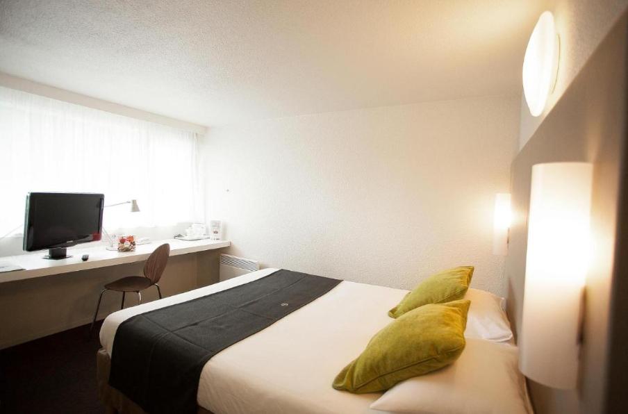 a hotel room with a bed with yellow pillows at Downtown in Cairo