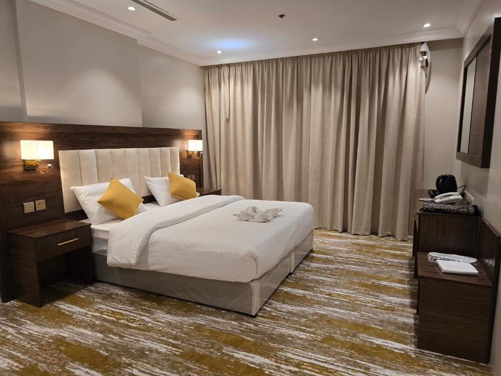 Postel nebo postele na pokoji v ubytování سحابة الأحلام - Dream Cloud Hotel