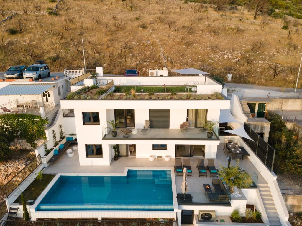 an aerial view of a house with a swimming pool at Villa Laganini in Rogoznica