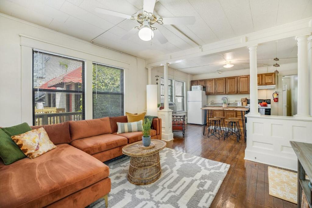a living room with a couch and a kitchen at The Clementine - Monthly Rental - Walk Everywhere in Fayetteville