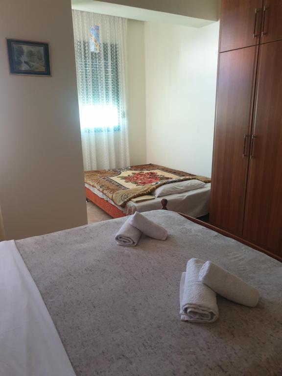 a bedroom with two towels on a bed at Armando's apartment in the center in Durrës