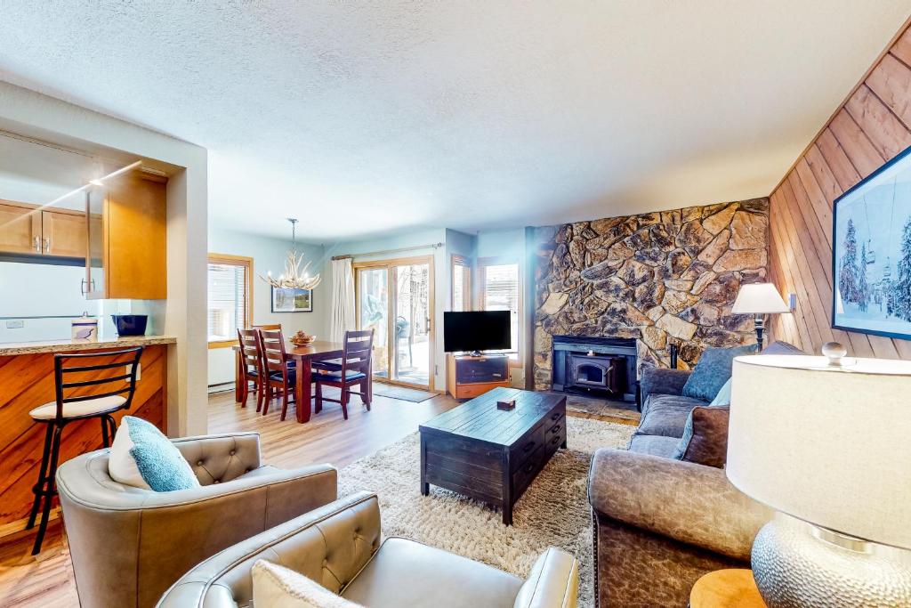 a living room with a stone wall at Snowcreek 443 in Mammoth Lakes