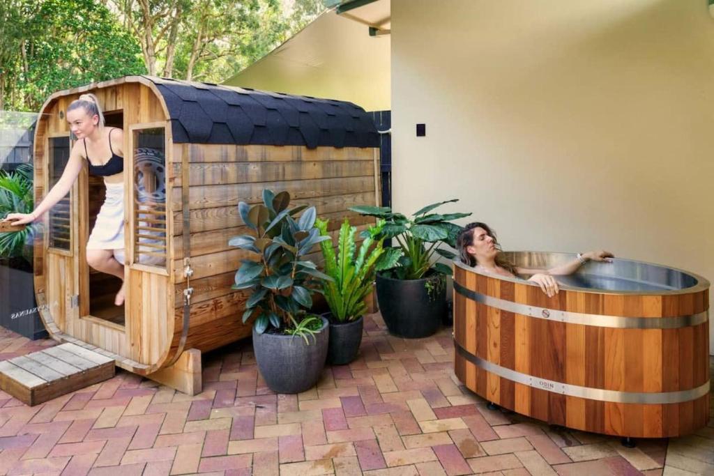 a couple of people in a hot tub in a sauna at Coolum Family Hideaway - Private Pool & Sauna in Coolum Beach