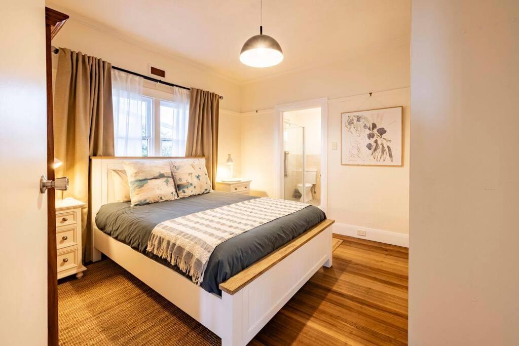 a bedroom with a bed and a window at Driftaway@Devonport in Devonport