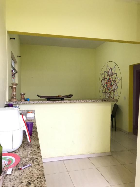 a kitchen with a counter top in a room at Hospedaria Dos Astros in São Thomé das Letras