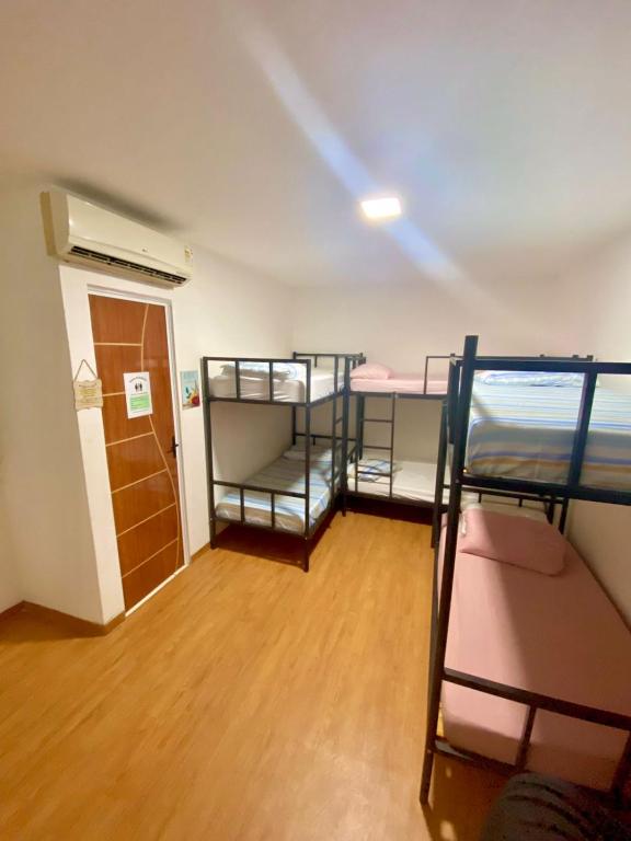 a room with three bunk beds and a hallway at Princesa Hostel in Belém
