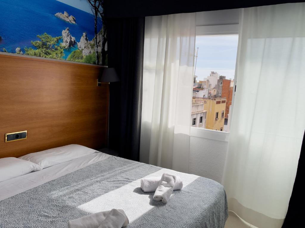 Postel nebo postele na pokoji v ubytování Hotel Maremagnum