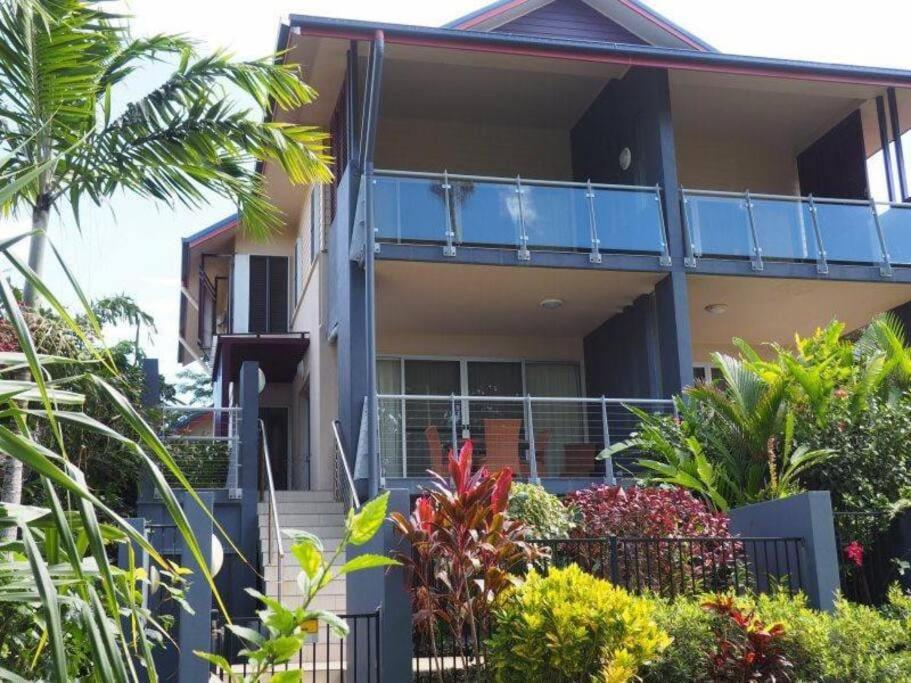 a house with a balcony and some plants at Beachfront Apartment 1 Beachfront Haven - 2 bed in Mission Beach