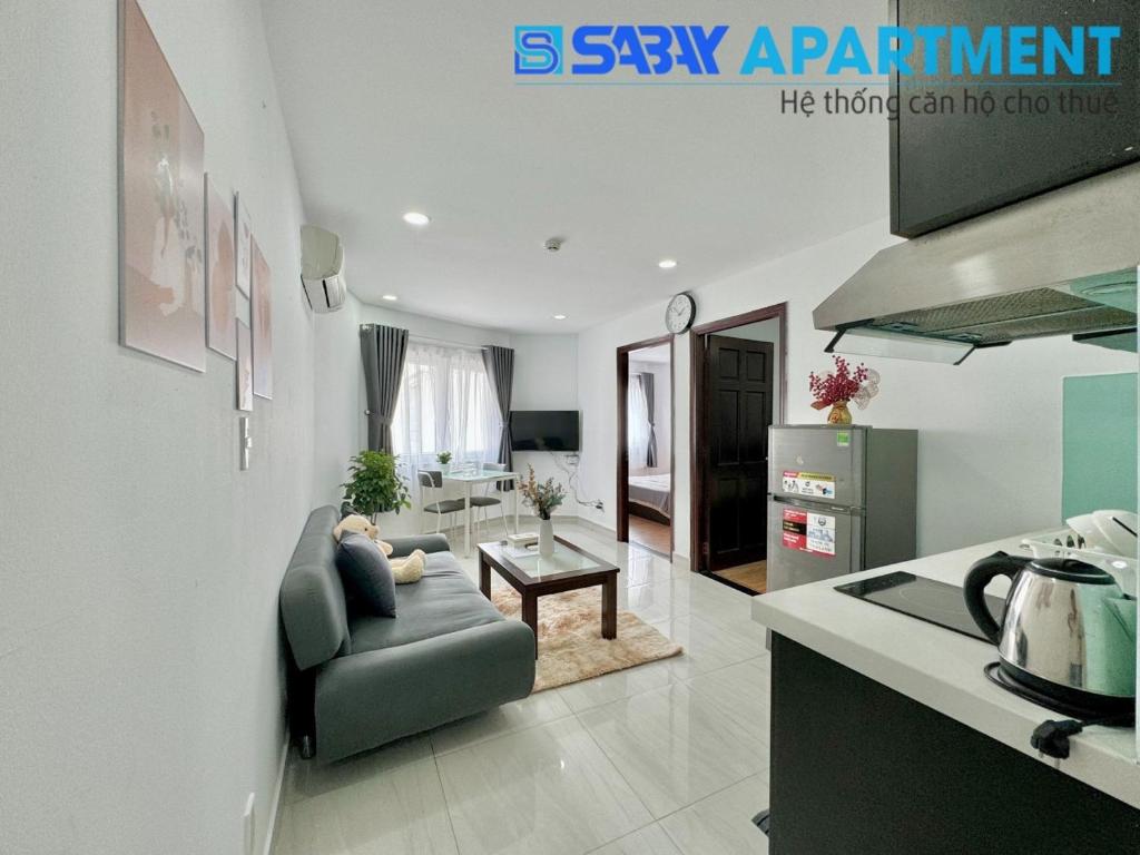 a living room with a couch and a table at Sabay Airport Apartment - The Connect in Ho Chi Minh City