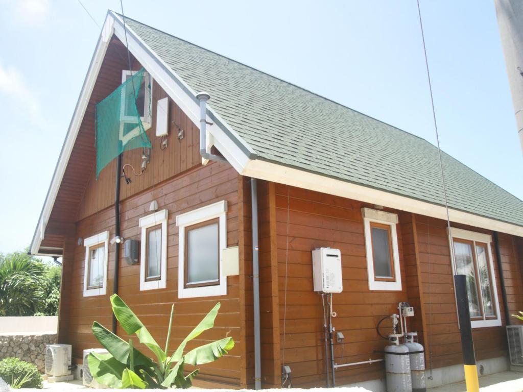 Una casa con una bandera a un lado. en 島ログ, en Isla Miyako