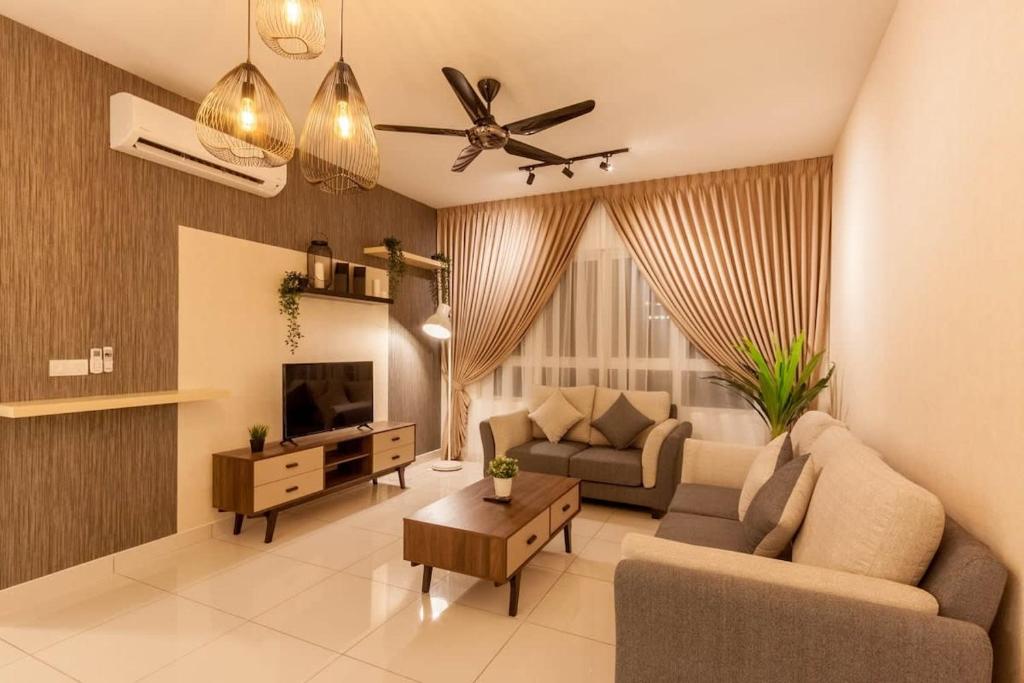 a living room with a couch and a tv at Tastefully Designed 3BR at Impiria Residensi Klang in Klang