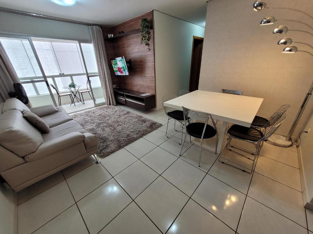 a living room with a couch and a table at Copaiba 3Q e 3B em Águas Claras - Brasília in Águas Claras
