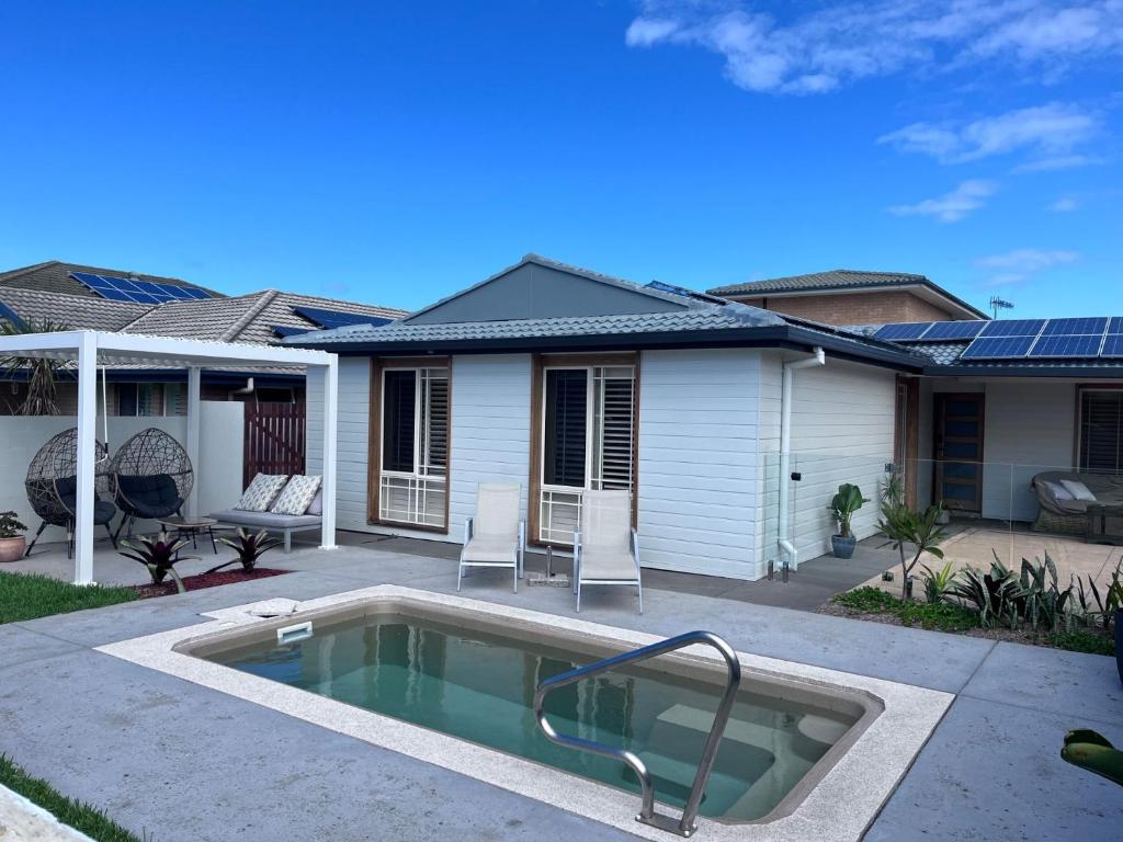 a house with a swimming pool in the yard at Toowoon Bay - Private Pool - Outside Shower in Long Jetty