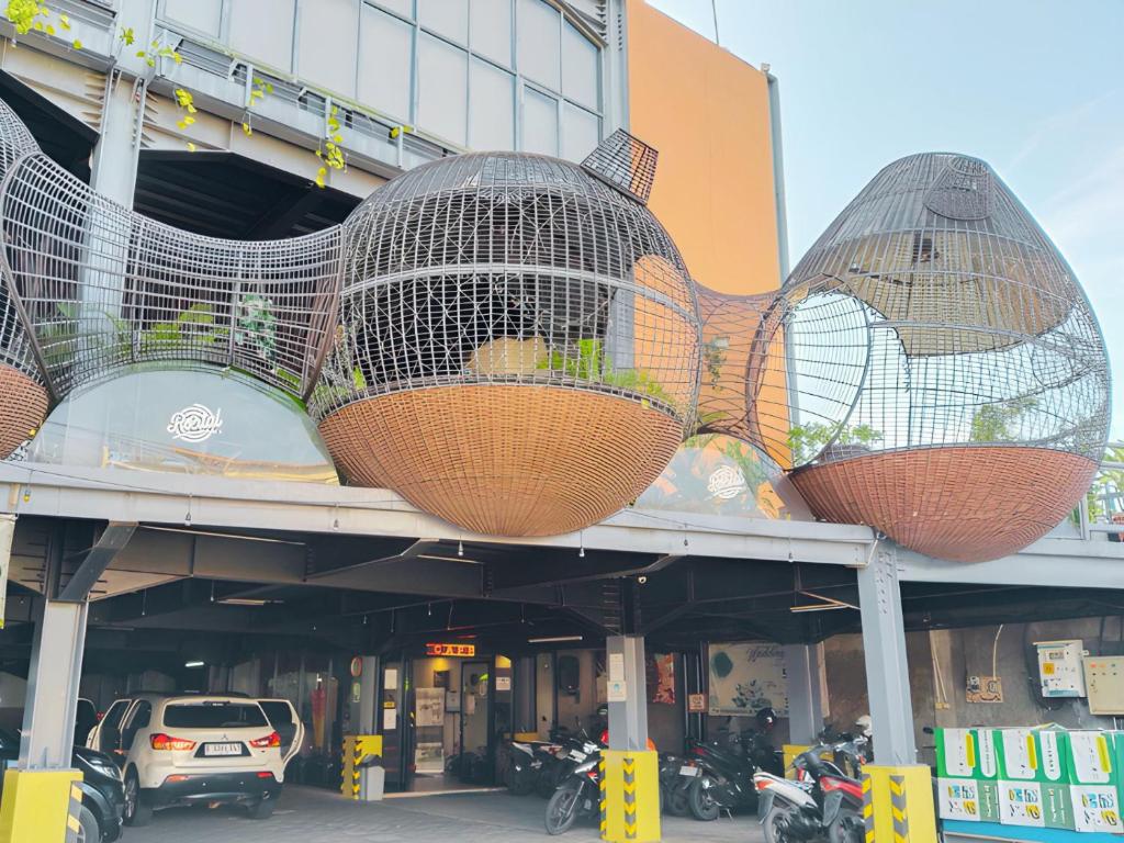 a building with three hanging baskets on the side of it at Portal Residence in Jakarta