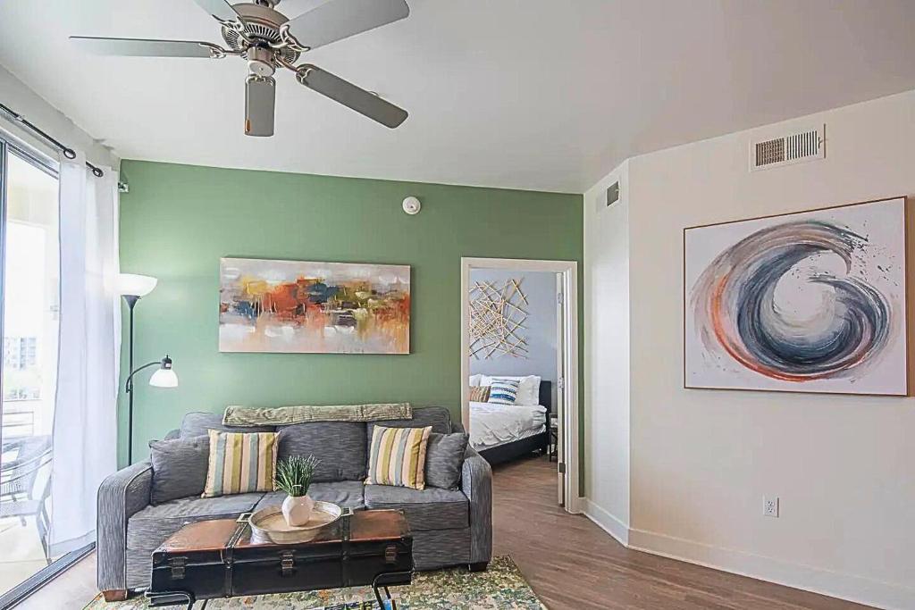 a living room with a couch and a ceiling fan at Shopping & Dining 1 Mile - 24 Hour Pool with Parking - 4036 in Phoenix