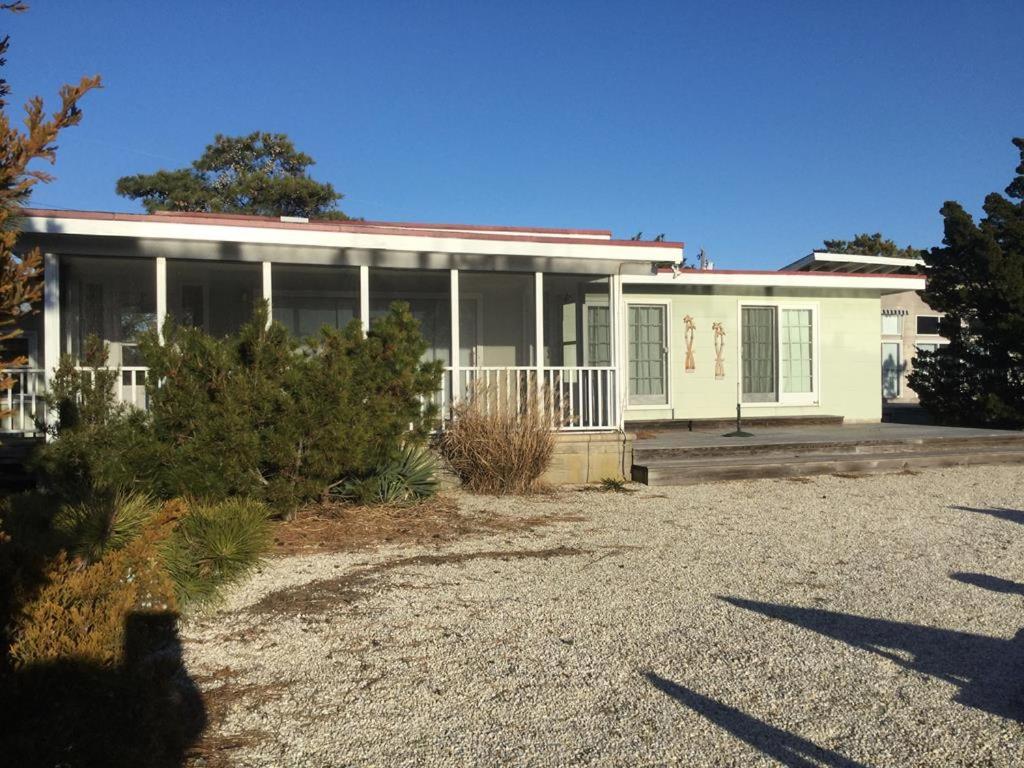 a large white house with a driveway in front of it at Classic Lagoon Front Home in Loveladies