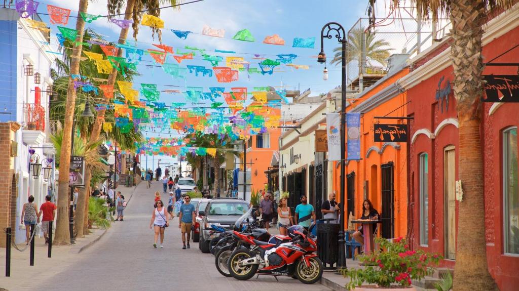 a city street with colorful flags and people walking down the street at Lumina at Cardinal San José del Cabo in San José del Cabo