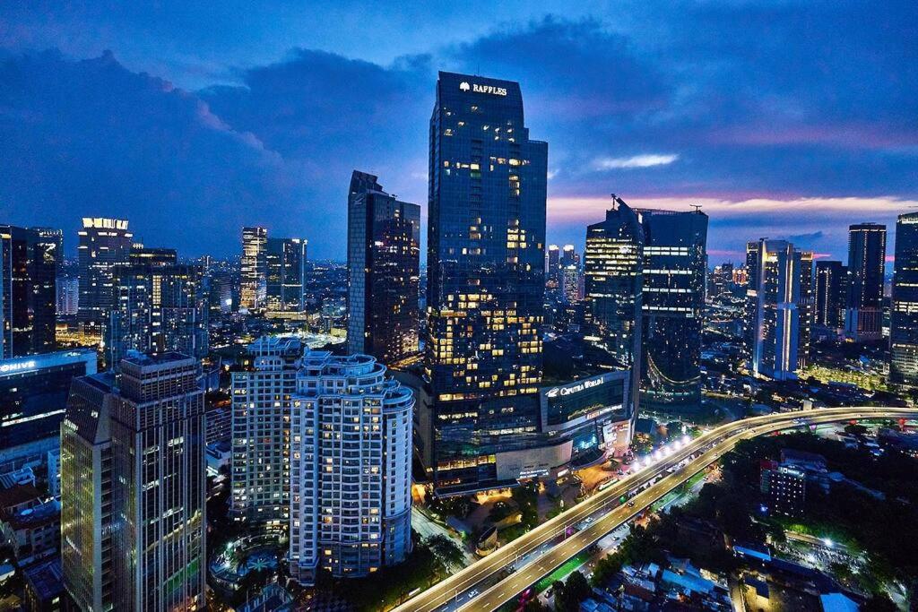 a city skyline at night with a lot of buildings at 2BR Magnificent View Apartment at ITC Kuningan in Jakarta