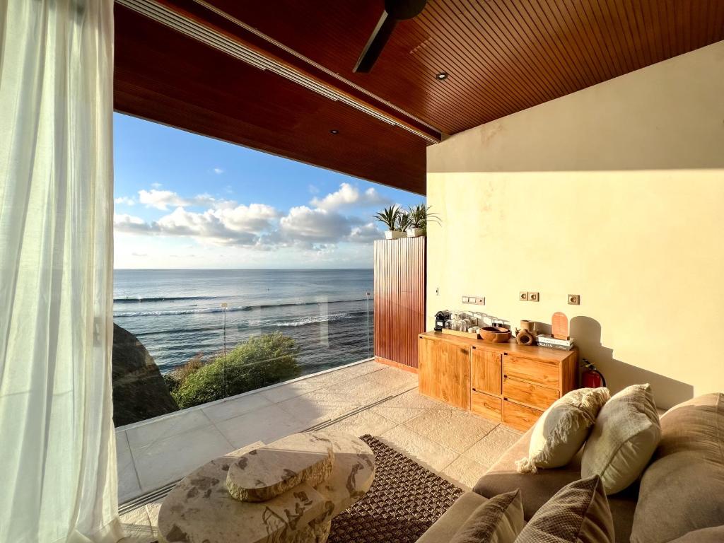a living room with a view of the ocean at Mahi Mahi Beach Shack And Suites in Uluwatu