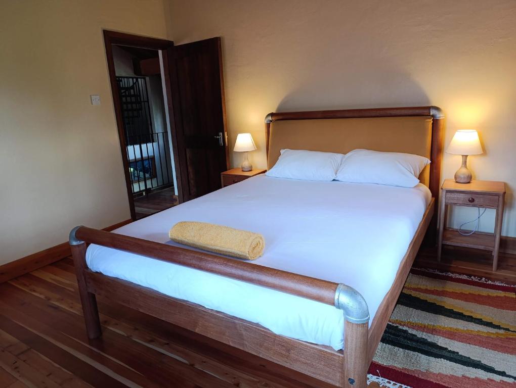 Postel nebo postele na pokoji v ubytování Amani House