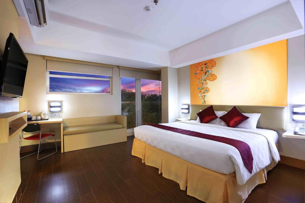 Postel nebo postele na pokoji v ubytování Cordela Hotel Cirebon