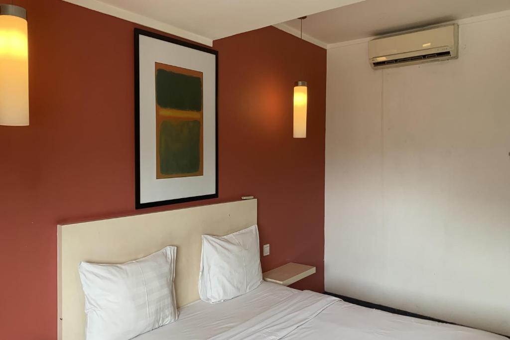 Postel nebo postele na pokoji v ubytování Hotel Glodok Plaza