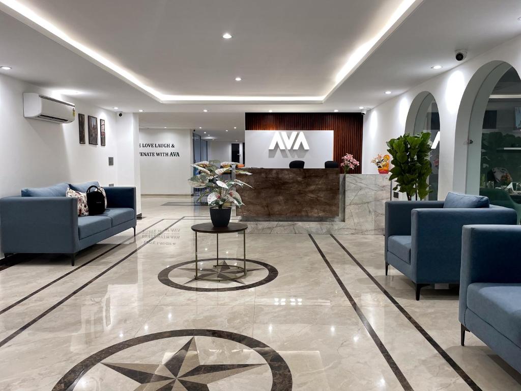 a lobby with couches and a table and a sign at AVA Hotels and Corporates Millennium City in Gurgaon